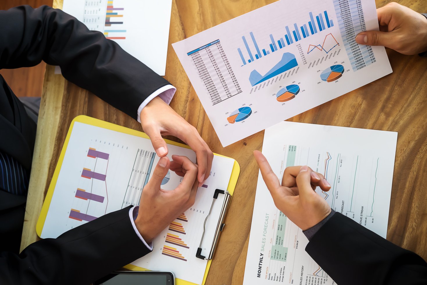 Business Meeting Over Financial Graphs